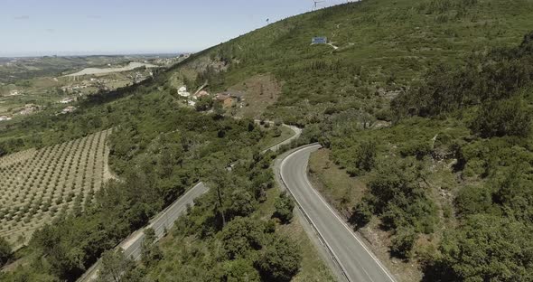 Flying Above The Road On The Lush Mountain In Reguengo Do Fetal In Batalha, Portugal With Distant Vi