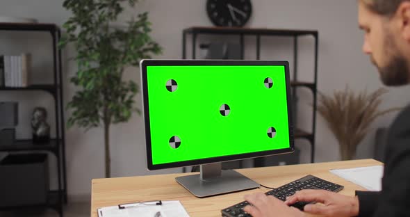 Businessman Using Computer with Green Screen