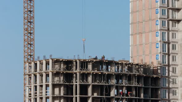 Crane Working on Construction Site Residential Housing Building in City Constructors Working Sunny 