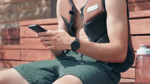 Surfer Texting Messages Outdoors