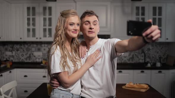 Video Chat By Couple on Smartphone in Kitchen 