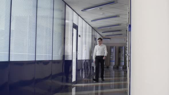 Business Man Walking in Hall of Large Corporate Building
