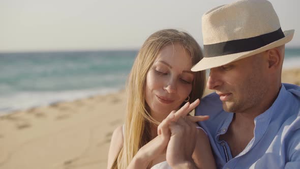 Couple in Love Holding Hands on Beach