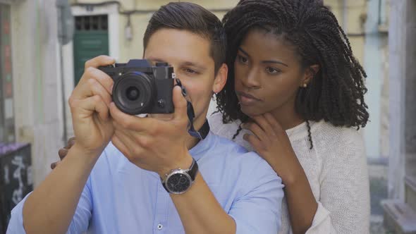 Excited Young Couple Taking Photos Outdoor