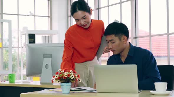 Two Business People Talk Project Strategy at Office