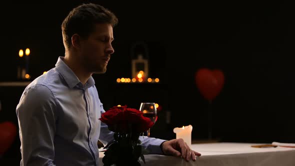 Anxious Male Blowing Out Candles and Leaving Bunch of Roses, Unsuccessful Date