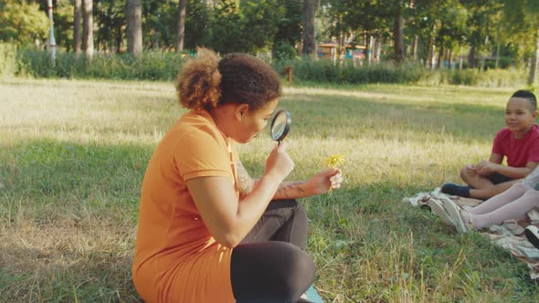 Group of Mixed Race School Children Having Biology Lesson Outdoors