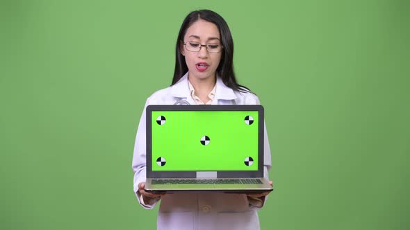 Young Beautiful Asian Woman Doctor Showing Laptop