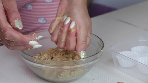 A Woman Rolls Balls Of Peanut Butter, Chocolate And Coconut Flour.