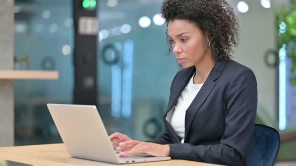 African Businesswoman Working on Laptop at Work 