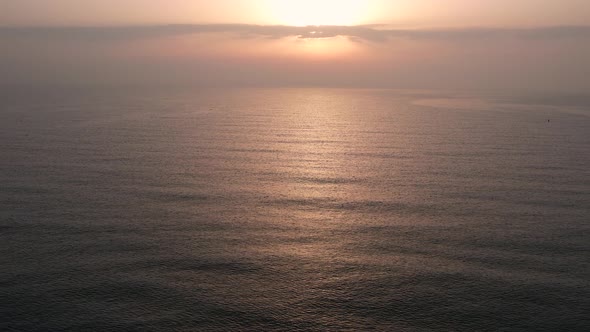 Fly over ocean, sea on sunrise. Close to the water