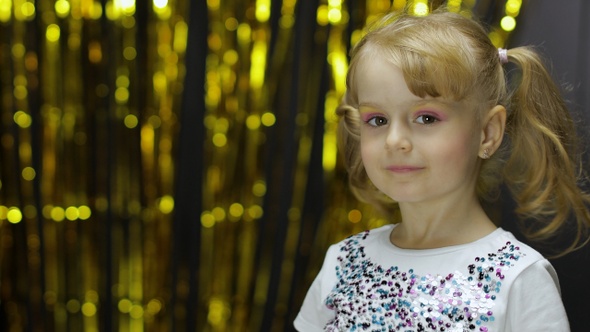 Child Dancing, Enjoying Music, Moving in Dynamic Winning Dance. Girl 4-5 Years Old in Shiny T-shirt