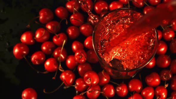 Super Slow Motion Cherry Juice Pours Into the Glass with Spray