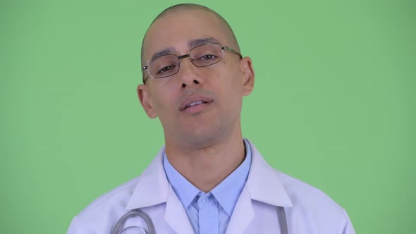 Face of Serious Bald Multi Ethnic Man Doctor Nodding Head No