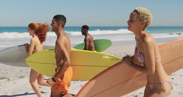 Young adult friends running at the beach 4k