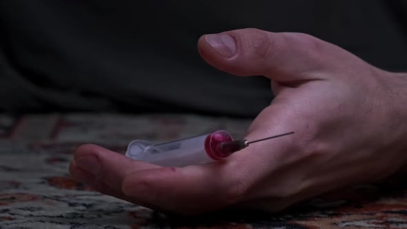 Overdose Addict's Hand Falls to the Floor Drug Syringe Falls Out of It