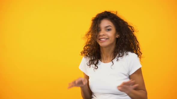 Cheerful Mixed-Race Female Moving to Music Rhythm, Celebrating Success, Relax