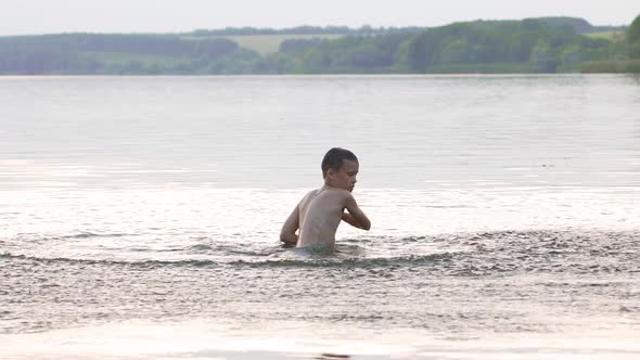 Little Kid Play in Water and Making Splash