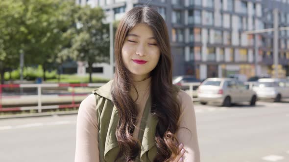 Young Asian Woman Smiles Camera Street Urban Area