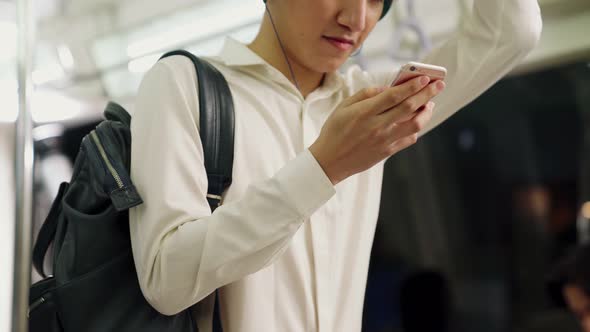 Businessman Using Mobile Phone on Public Train