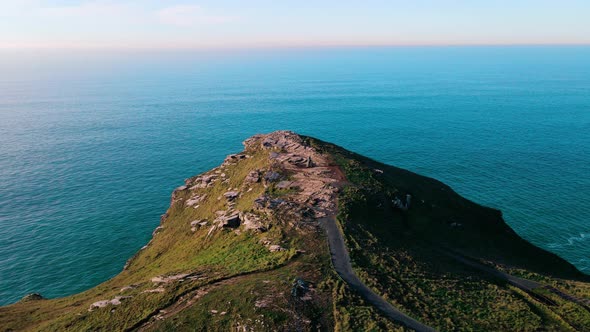 Monument to King Arthur in Britain Aerial view of a rock on a background of the sea