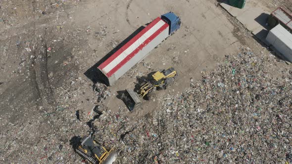 Garbage Truck and Industrial Bulldozer on Waste Landfill