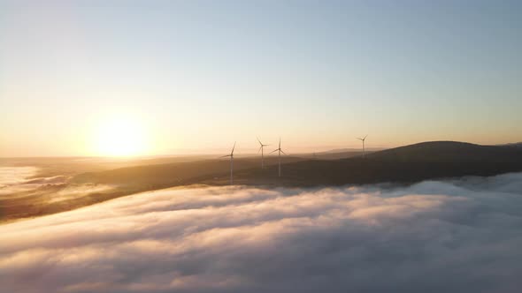 Wind Farm in the Fog at Sunrise