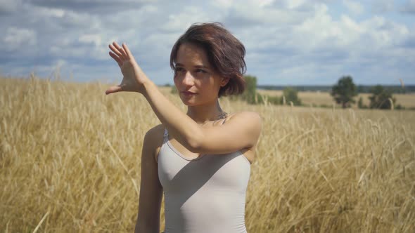 Chic Woman Wearing Bodysuit Presenting Something and Shows Ads By a Hand in the Air