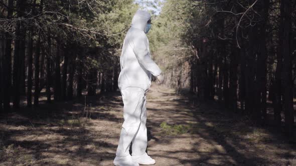 Funny Dance of Young Caucasian Man in White Protective Clothing, Eyeglasses and Face Mask. Active