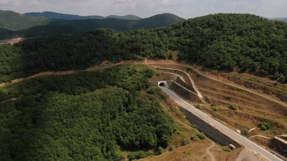 Car Enters Tunnel Aerial Top View Drone Above Greece Daytime Summer  Footage