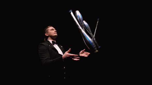 Camera Rotates Around Circus Juggler Using Pins To Juggle