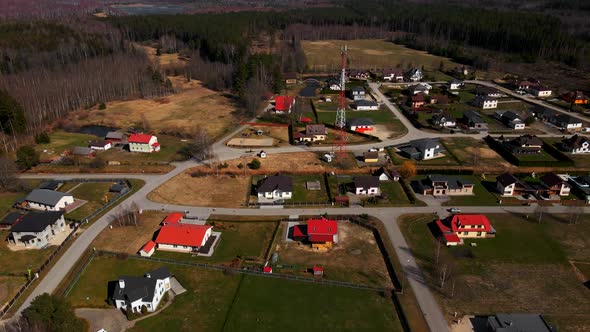 Aerial Pan Right Residential Houses with Cellular Tower in Centre