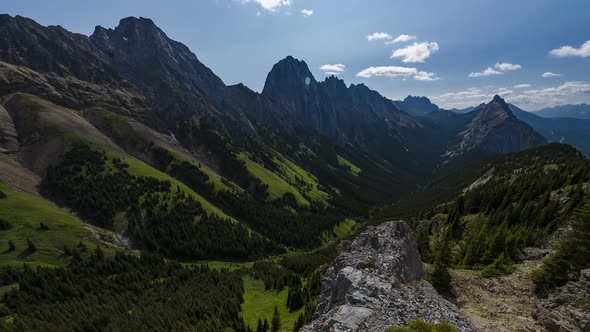 Vibrant Green Valley Between Towering Mountains  Time Lapse