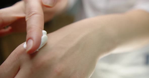 Beautician Applies Cream On Hand In A Beauty Salon. Beauty Clinic Concept 