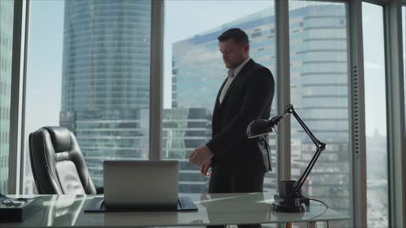 A Businessman Is Sitting at a Table in a Luxurious Office. A Businessman in His Office on a High