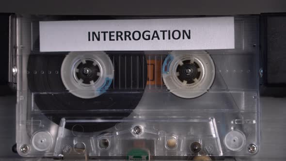 Interrogation Recording on Audio Cassette Tape in Vintage Deck Player Close Up