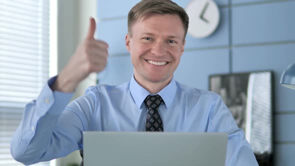 Thumbs Up By Businessman at Work