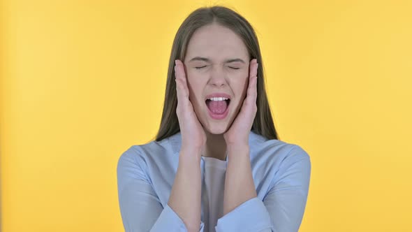 Portrait of Shouting Young Woman Screaming Loud, Yellow Background