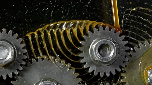 Super Slow Motion Shot of Gear Mechanism and Oil on Dark Background at 1000 Fps