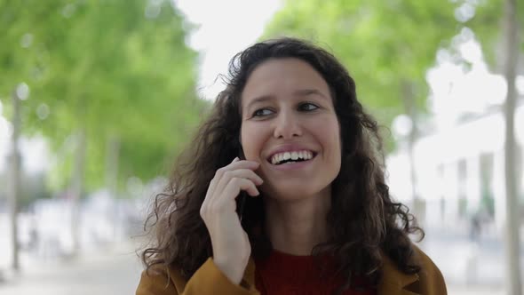 Happy Young Woman Talking By Cell Phone Outdoor