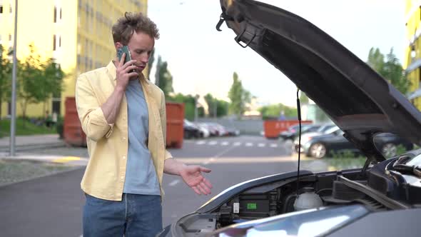 Young man asks someone for advice on car repair.