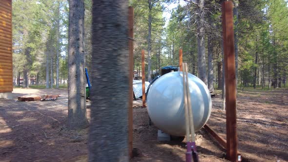 Large propane storage for an outdoor cabin in the woods.