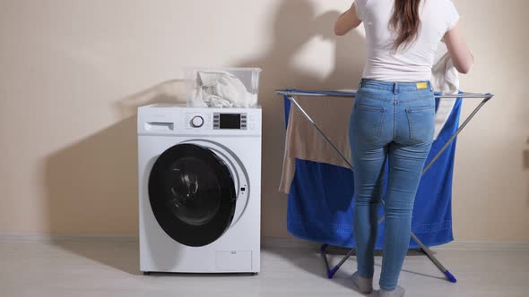 Lady Takes Laundry of Washing Machine and Hangs Out on Rack