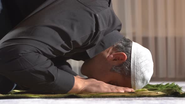 Muslim man praying at home.