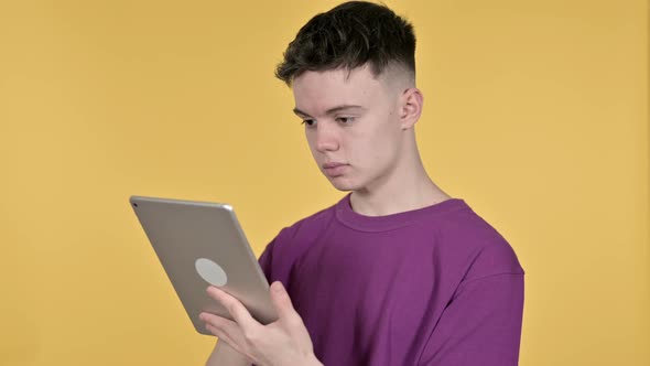 Young Man Browsing Internet, Using Tablet