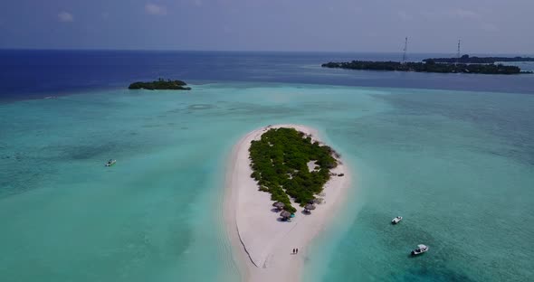 Daytime aerial abstract shot of a summer white paradise sand beach and blue ocean background in 4K