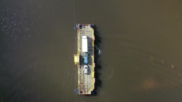 Aerial view panning away from a cable ferry in the archipelago of Porvoo, sunny, spring day, in Uusi