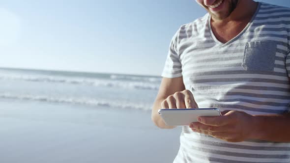 Man using mobile phone at beach