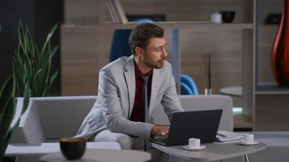 Young Businessman Working Laptop Computer Waiting Colleague in Remote Workplace