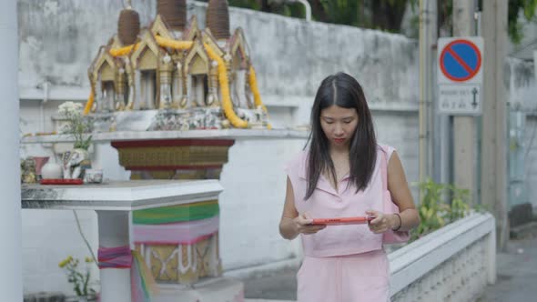 A Girl Was Walking Down the Street Playing Games on Her Mobile with Great Attention